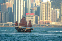 a junk sailing across the harbour