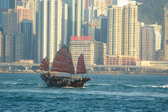 a junk sailing across the harbour