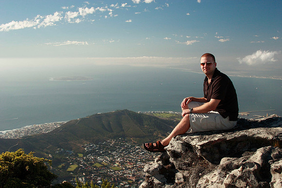 rick sitting on table mountain with the city and signal hill in the background
