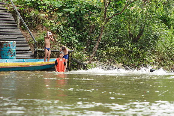 children taking a bath in the river