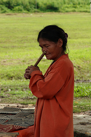 local woment playing a flute through her nose