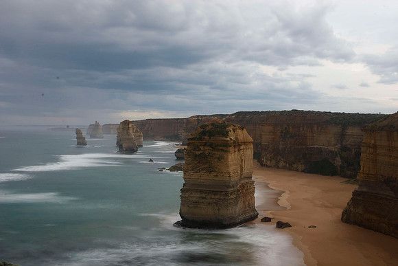 12 apostles at sunset on a dark, cloudy and rainy day