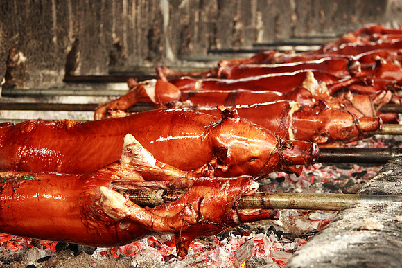 lechon (roast pig) roasting over an open fire