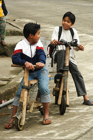 local kids with wooden scooters