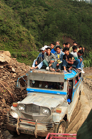 passing a local jeepney where the locals had to ride on top